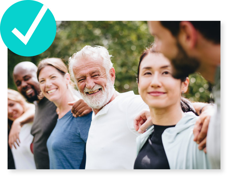 Photo of smiling diverse people with white check mark inside teal circle in upper left